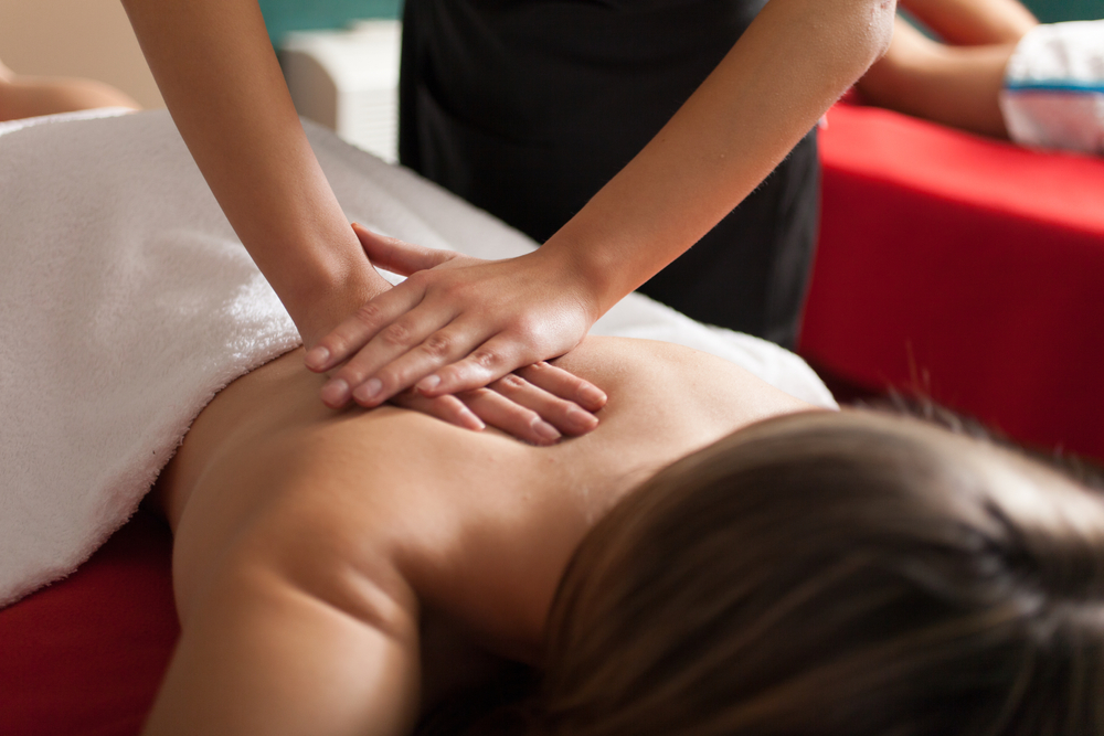 hands of massage therapist pounding the back of a woman- Pan Thai Massage - Sugar Lang, TX